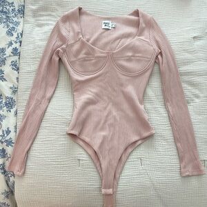 Blush colored ribbed long sleeve Princess Polly bodysuit